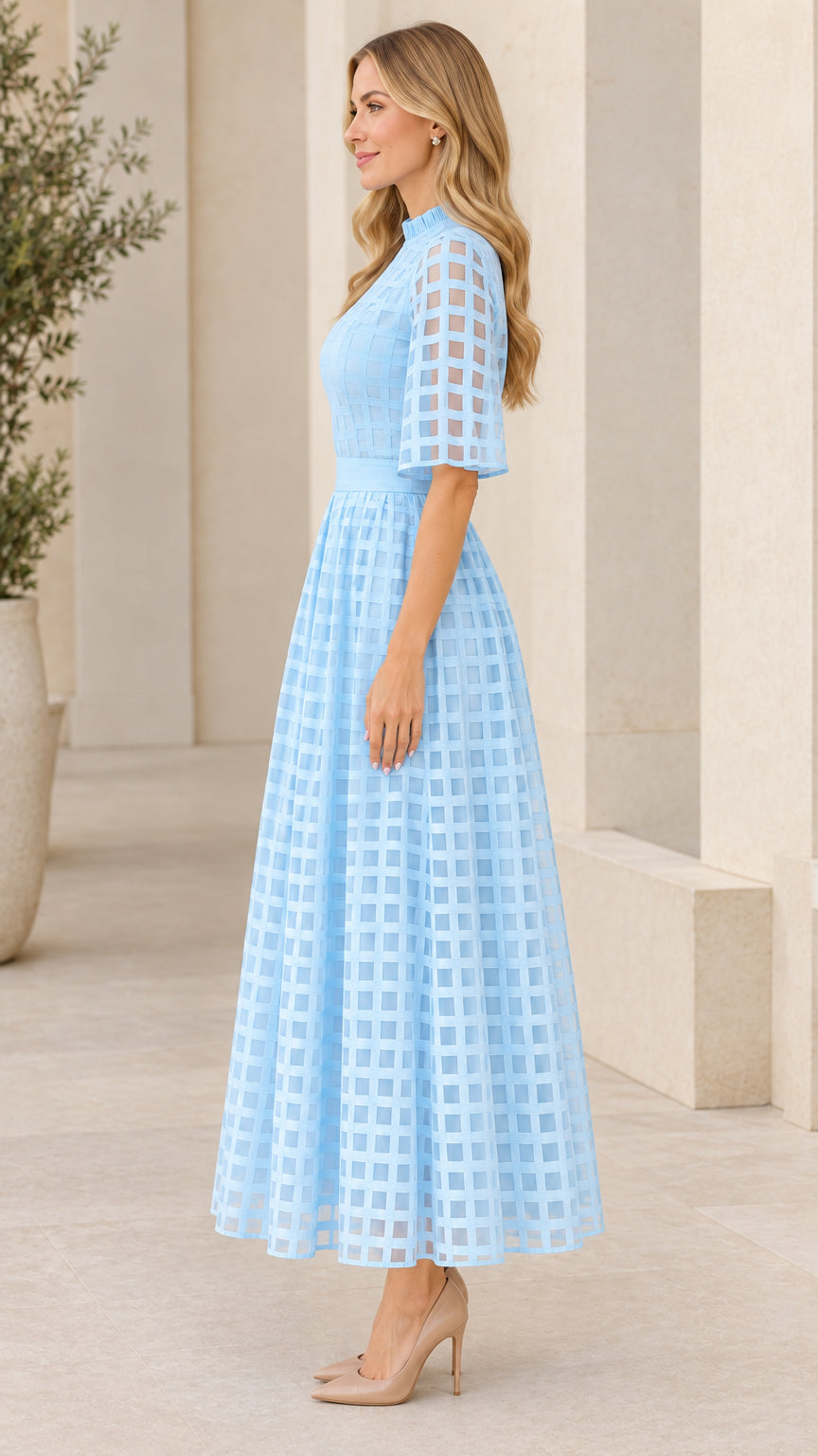 Side profile of woman wearing light blue sheer grid maxi dress with flutter sleeves