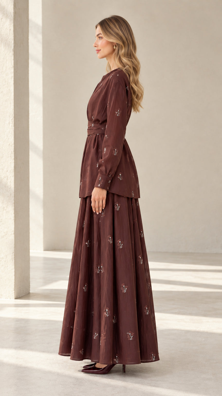 Side profile of model wearing brown modest two-piece tunic and maxi skirt outfit