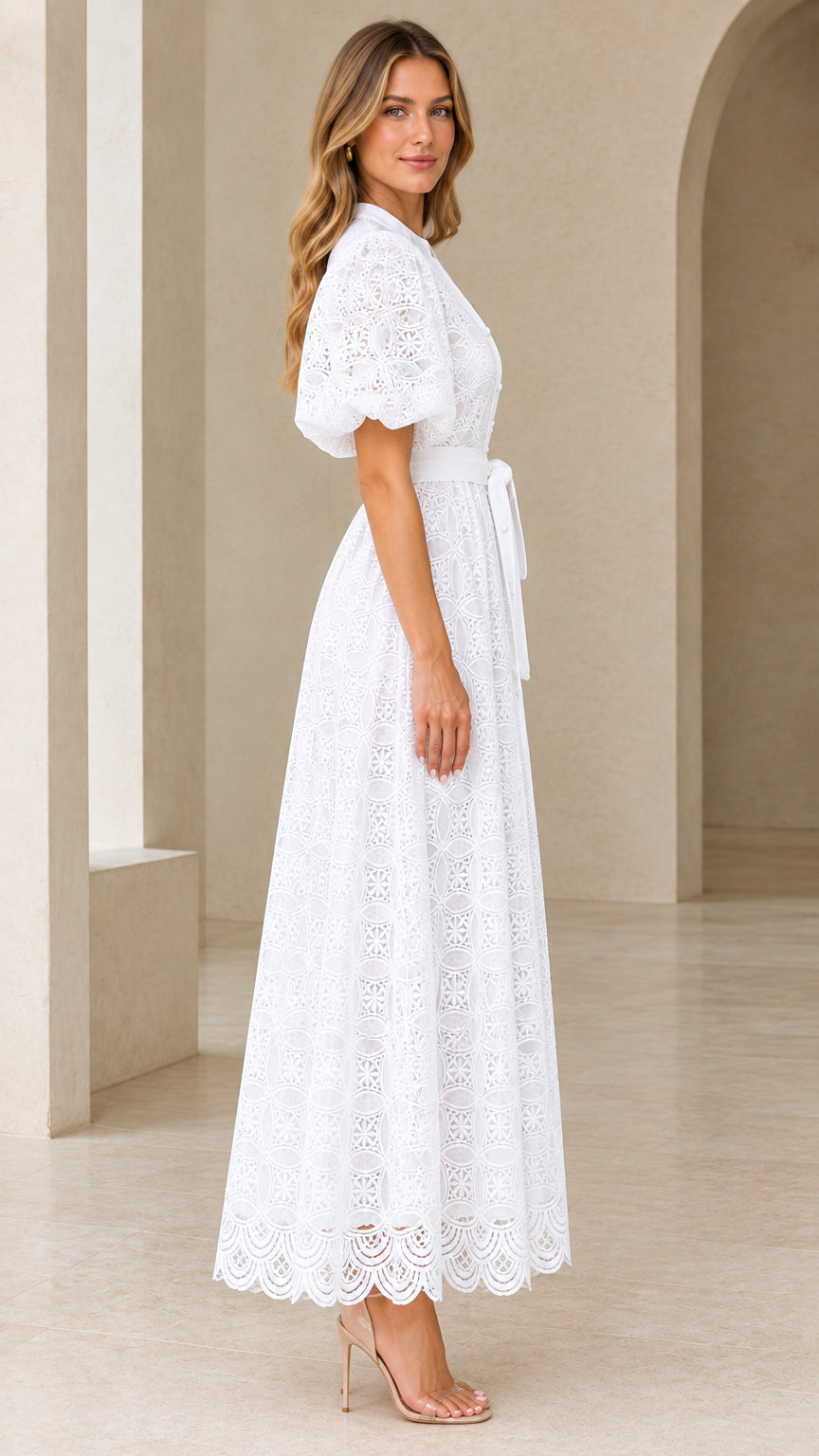 Side profile view of model in white embroidered lace button-front maxi dress
