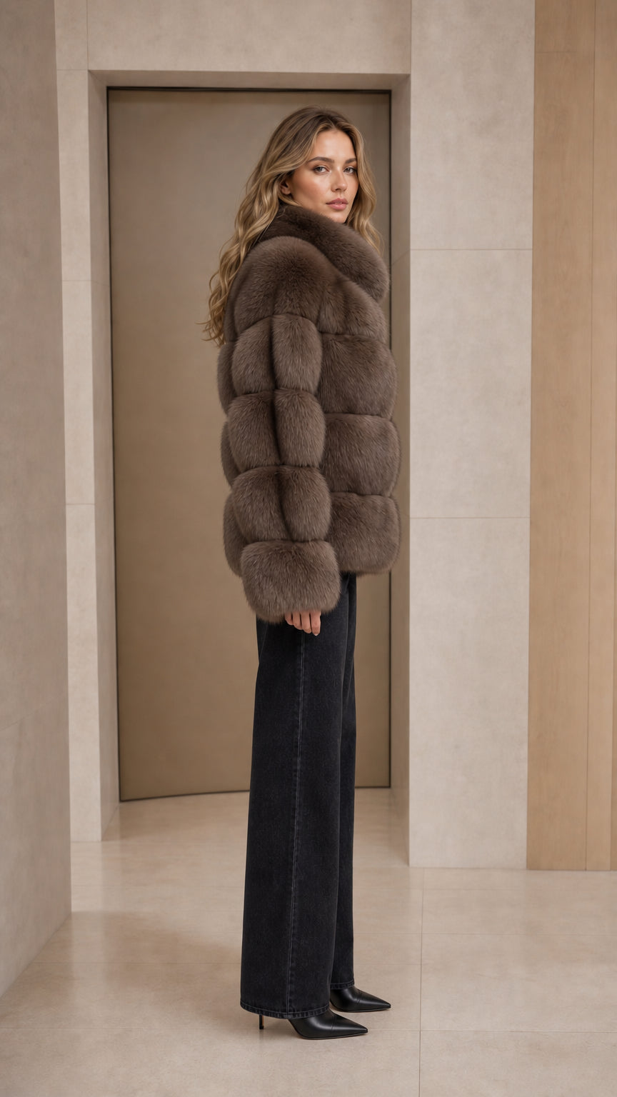Side angle view of model wearing taupe stand collar faux fur coat