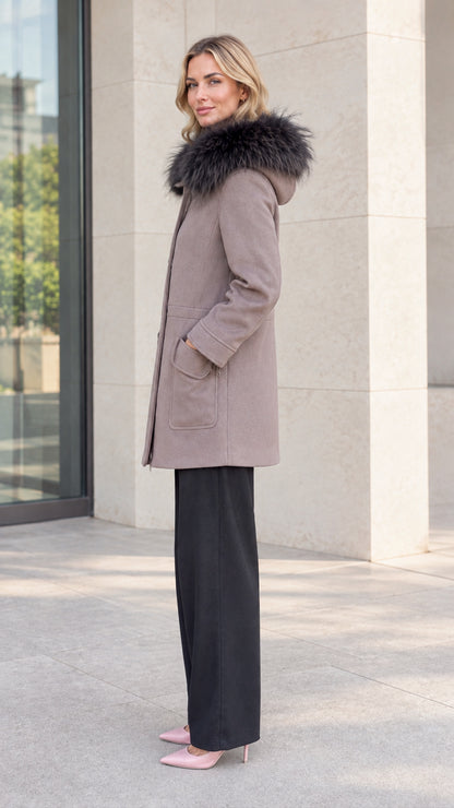 Side profile view of model wearing taupe mid-length hooded coat