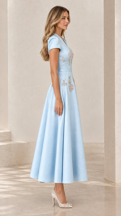Side profile view of light blue short sleeve embroidered cocktail gown