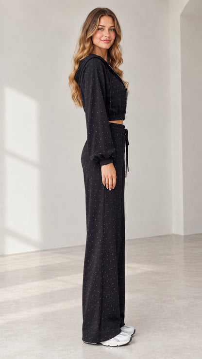 Side profile view of model wearing black sparkle 3-piece lounge set