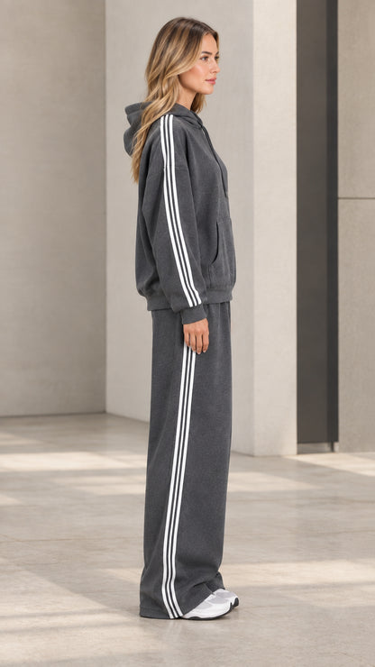 Side profile view of model wearing charcoal grey striped hoodie and sweatpants set