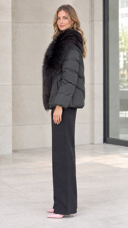 Side profile view of model showcasing the black faux fur collar puffer jacket silhouette