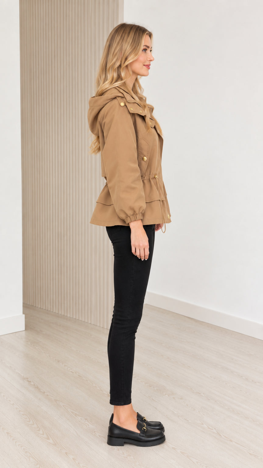 Side profile view of model wearing camel drawstring waist utility jacket