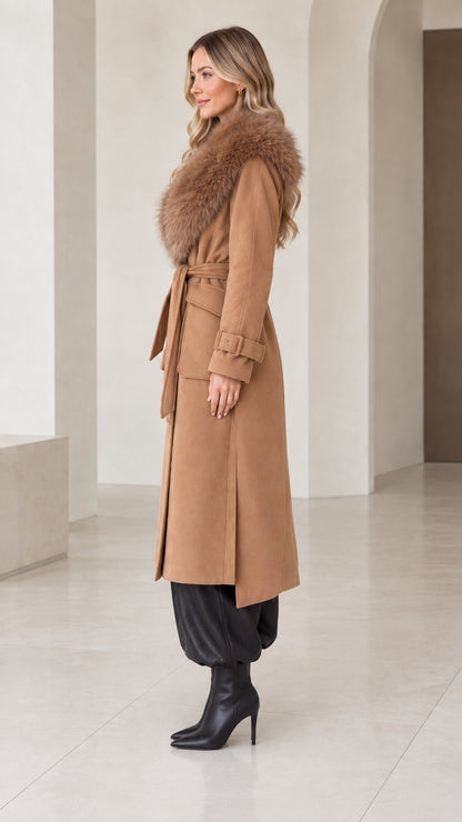 Side angle view of model wearing camel belted longline overcoat with faux fur trim