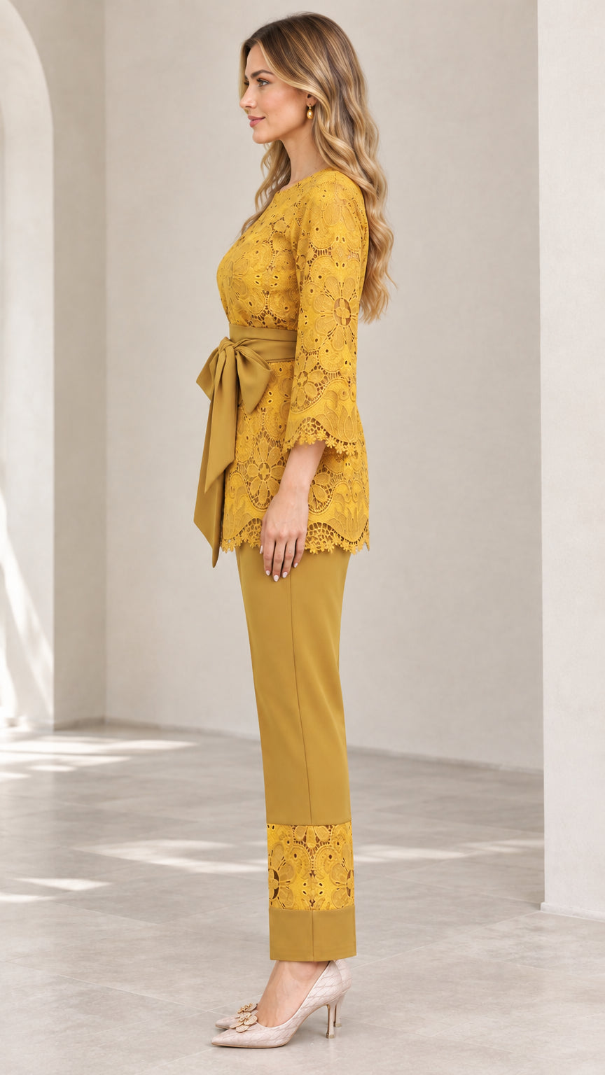 Side view of woman in mustard yellow 2-piece lace pant suit