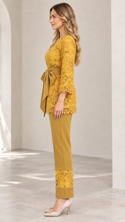 Side view of woman in mustard yellow 2-piece lace pant suit
