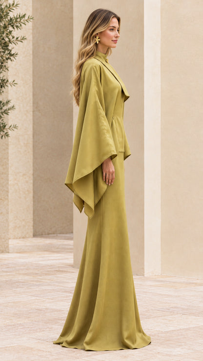 Side profile view of olive green cape maxi gown showing drape