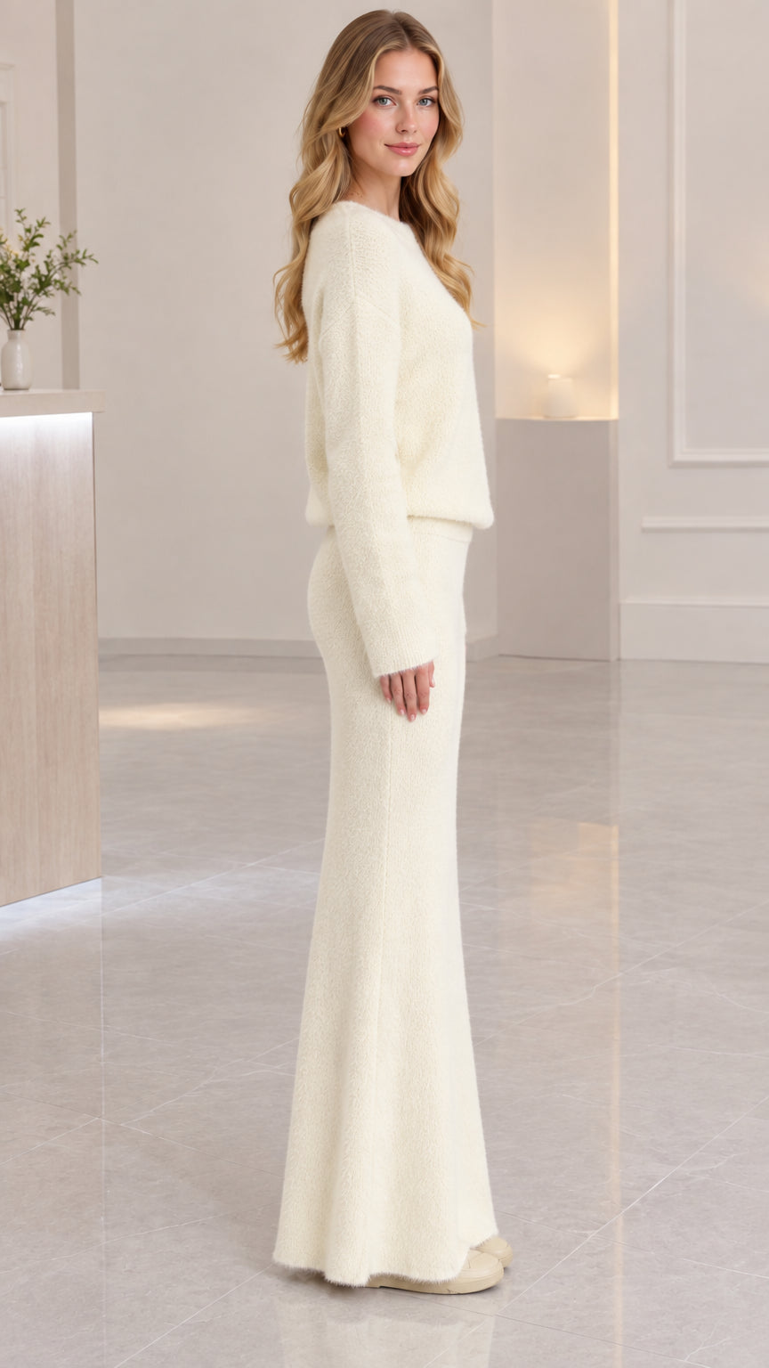 Side profile of cream fuzzy knit long-sleeve top and maxi skirt set