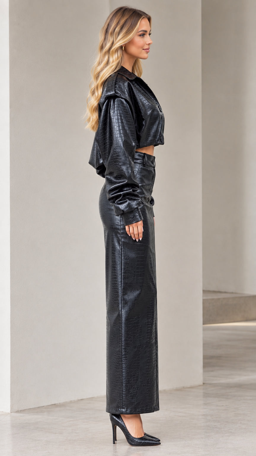 Side profile view of black crocodile embossed faux leather two-piece maxi skirt set