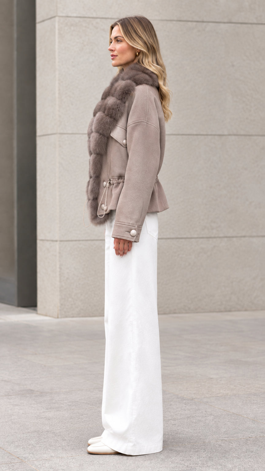 Side profile view of taupe faux fur trim short jacket