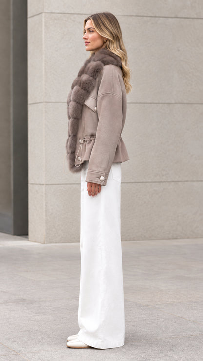 Side profile view of taupe faux fur trim short jacket
