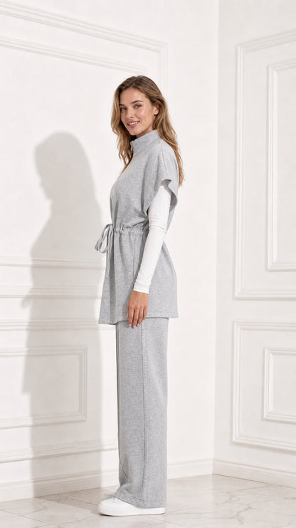 Side profile view of women's heather grey drawstring tunic vest and matching trousers