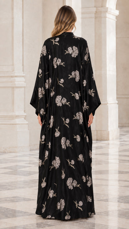 Back view of woman wearing black embroidered loose fit kaftan gown