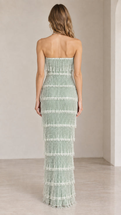 Back view of model in sage green strapless beaded fringe evening gown