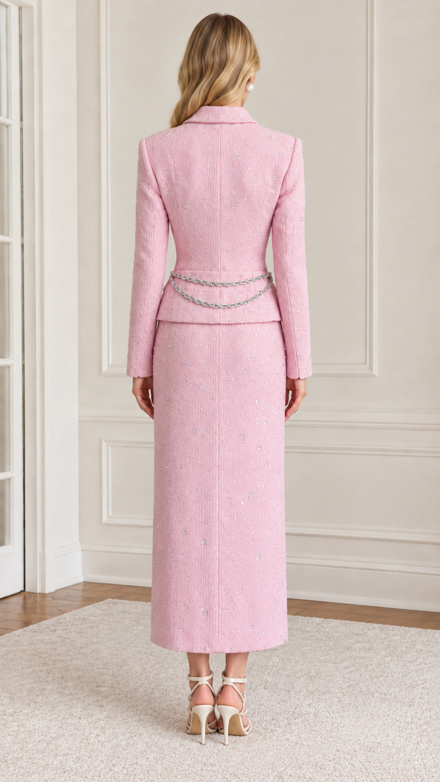 Back full-length view of tailored pink tweed jacket and long skirt set