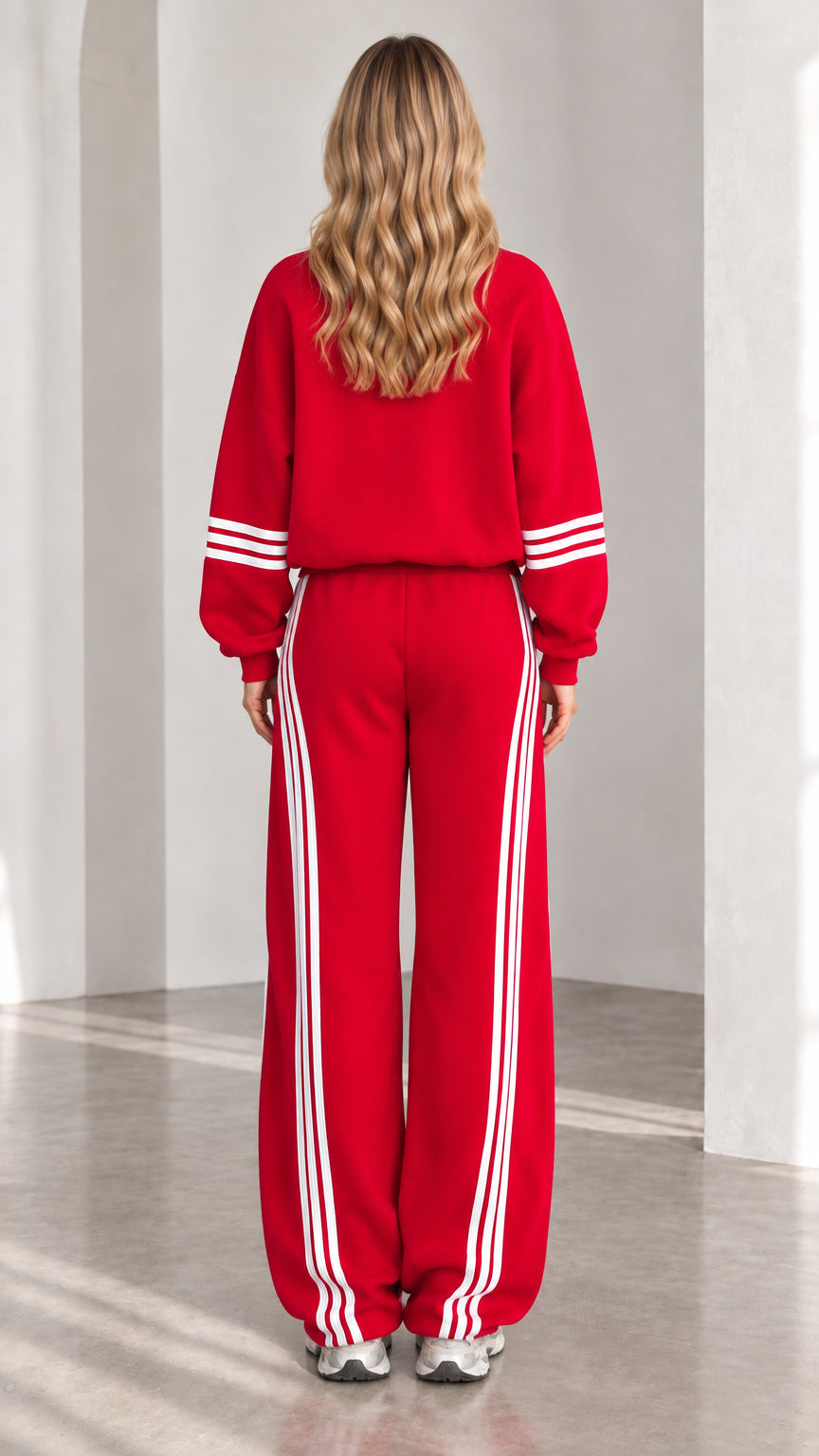 Back view of woman wearing red zip-up tracksuit set