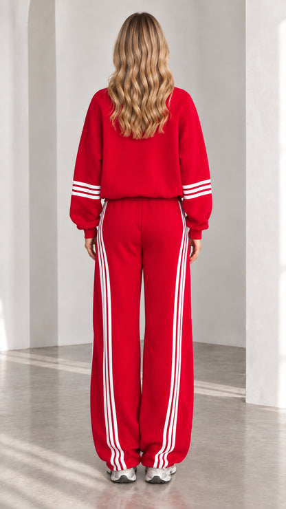 Back view of woman wearing red zip-up tracksuit set