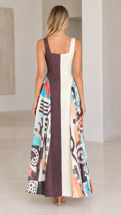 Back view of model wearing chocolate brown and cream two-tone maxi dress with abstract pattern sides