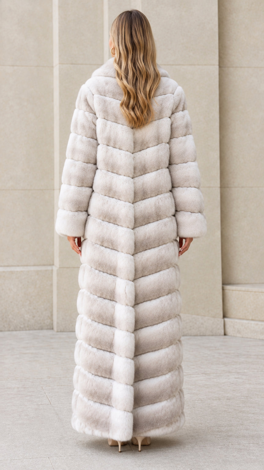Back view of model showing chevron seam construction on Light Gray maxi fur coat
