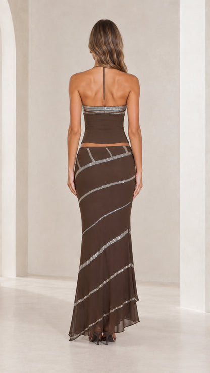 Back view of chocolate brown halter neck crop top and low-rise maxi skirt set