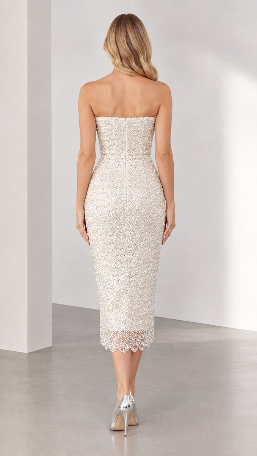 Back view of ivory strapless sequin midi dress showing tailored fit and zip closure