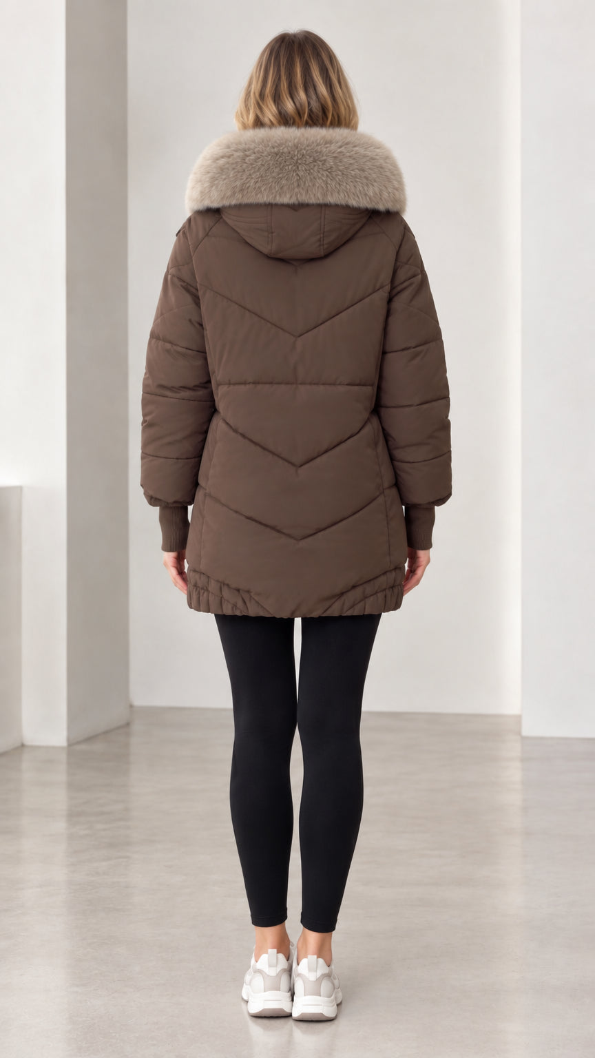Back view of model showing chevron quilted pattern on brown winter parka coat