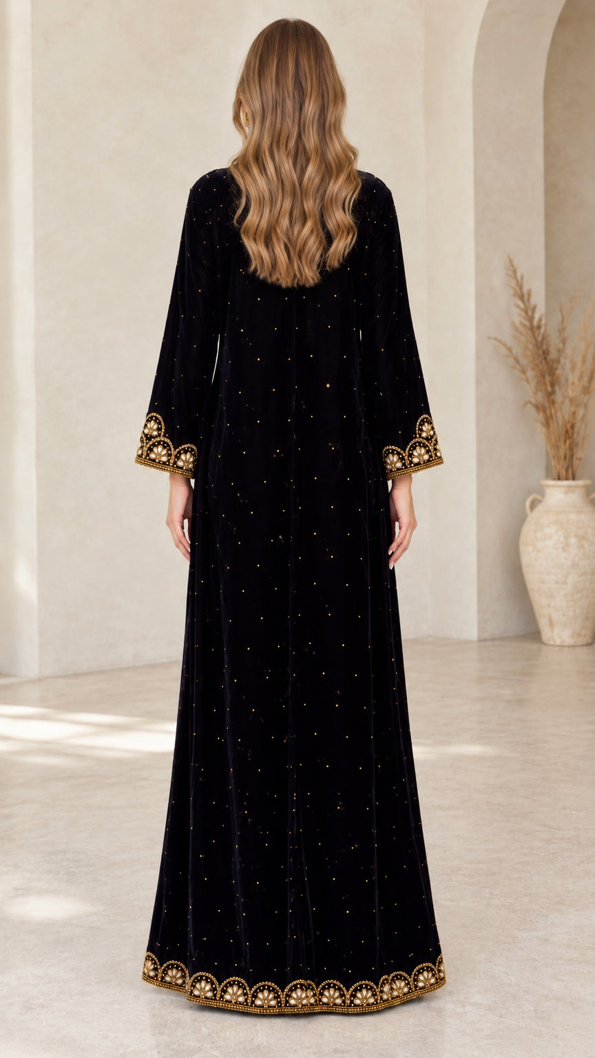Back view of black velvet long sleeve embroidered gown