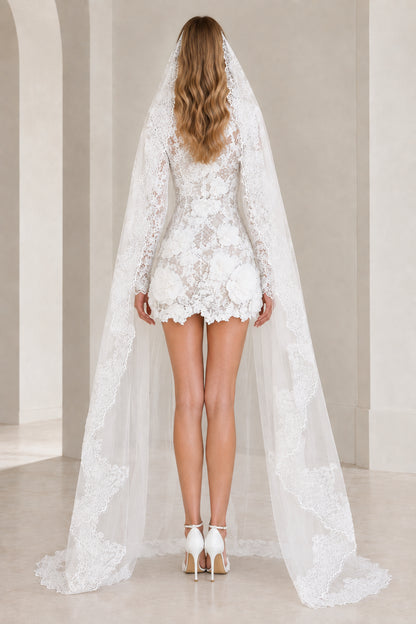 Back view of white floral lace mini dress and matching long lace veil