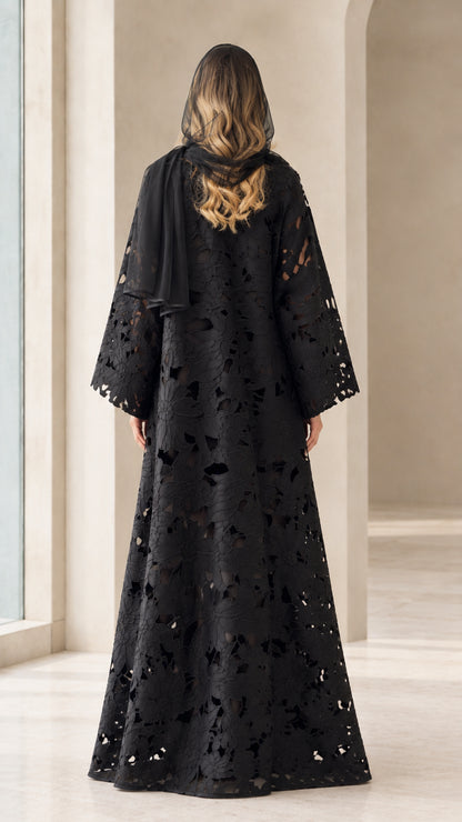 Back view of model in black floral cutwork abaya showing floor-length drape