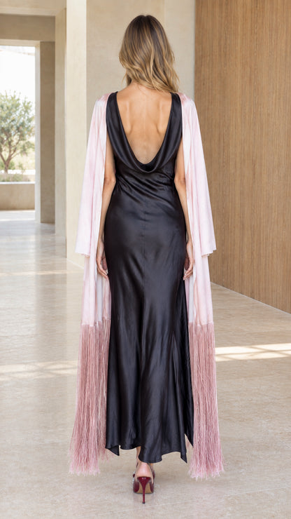 Back view of black cowl-back satin maxi dress and blush pink duster with fringe hem