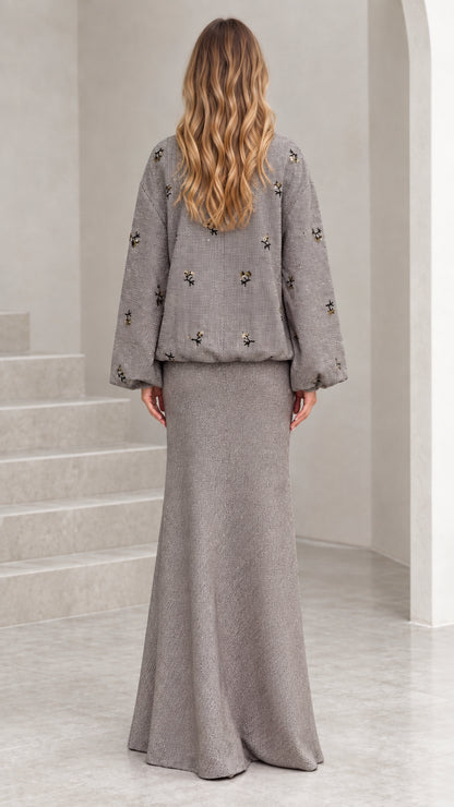 Back view of woman wearing grey embellished tweed two-piece skirt set