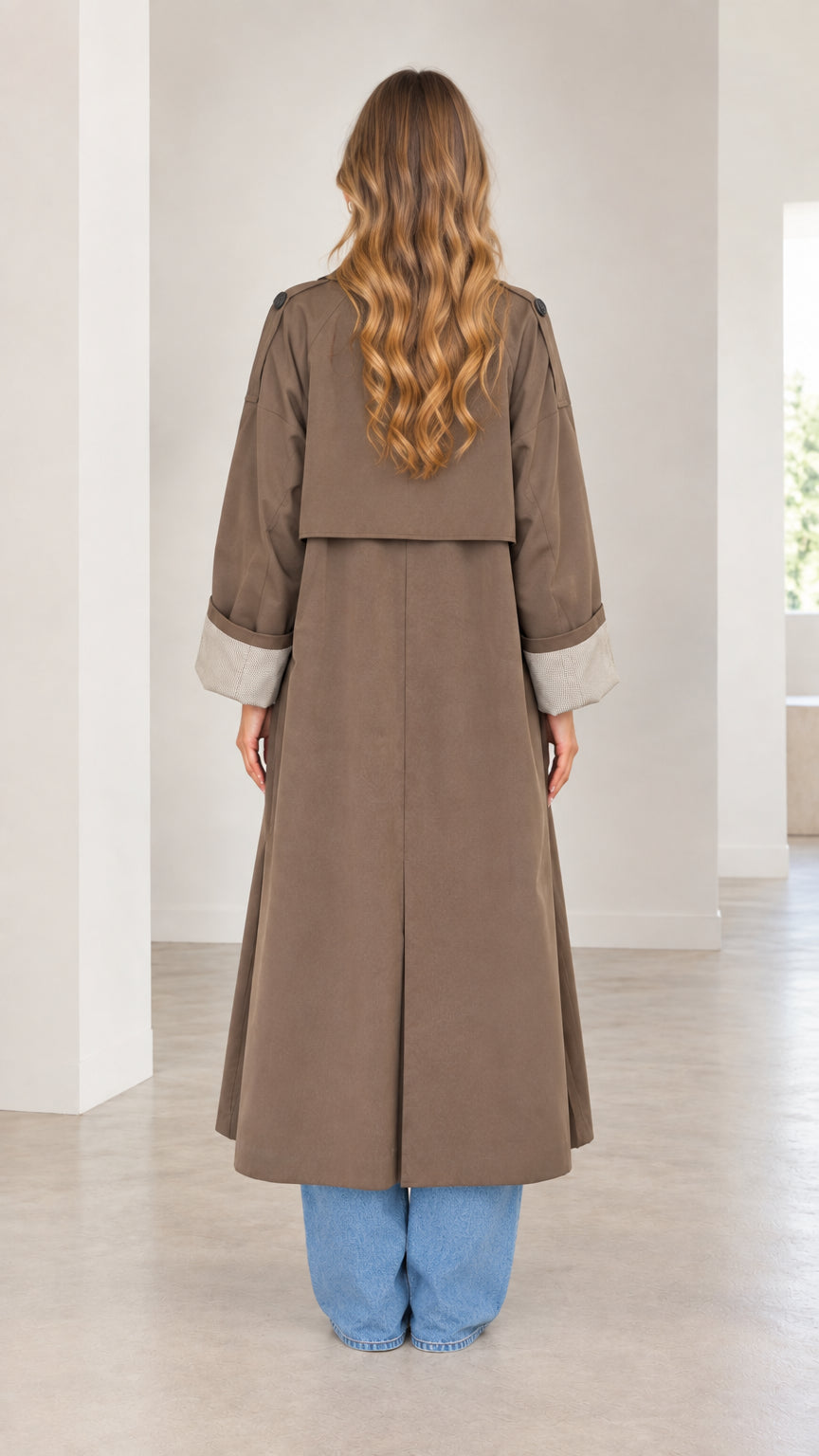 Back full-length view of mocha brown maxi trench coat highlighting storm flap and back vent