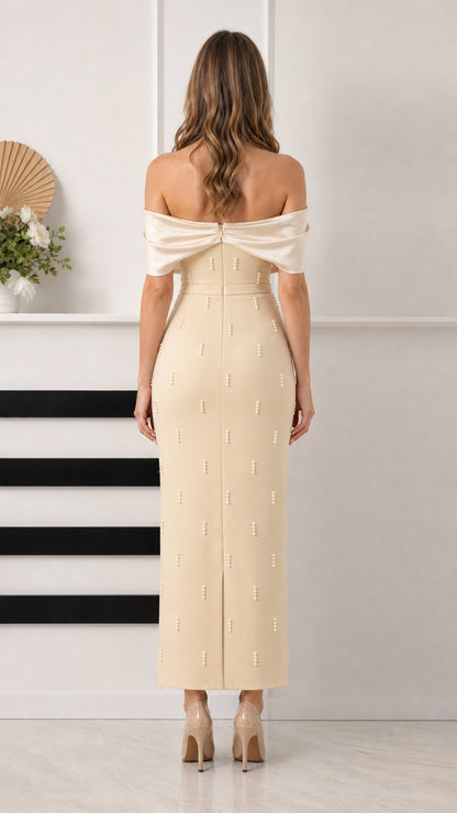 Back view of champagne column formal gown showing back slit and draped back sleeves