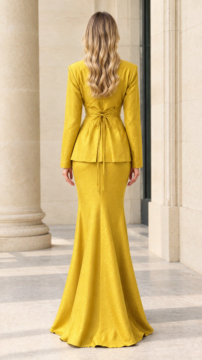 Back view of woman showcasing tie-back waist on yellow two-piece formal skirt set