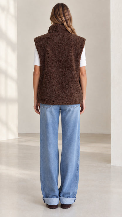 Back view of woman wearing brown plush sherpa fleece vest