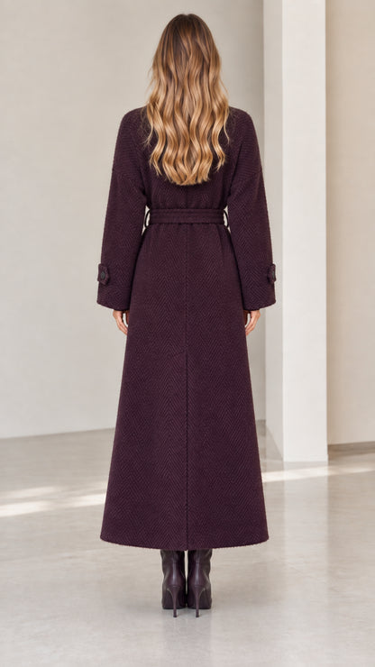 Back view of woman wearing deep plum herringbone maxi coat