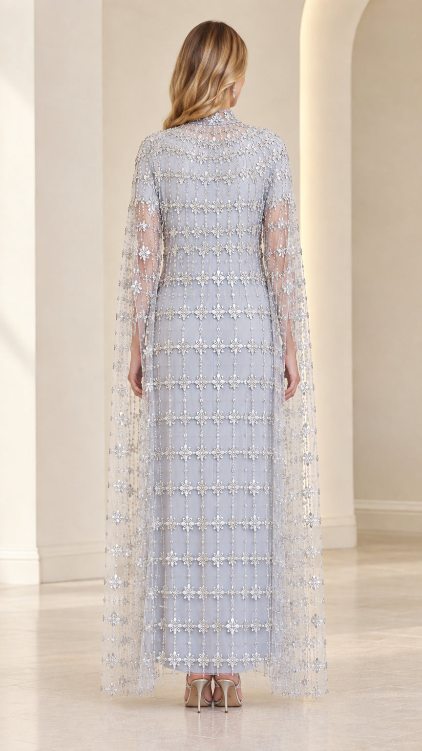 Back view of model in Ice Blue crystal-beaded cape evening gown