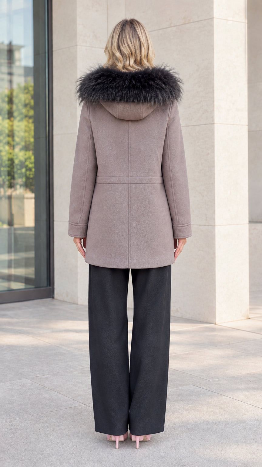Back view of model showing hood with faux fur trim and mid-thigh coat length
