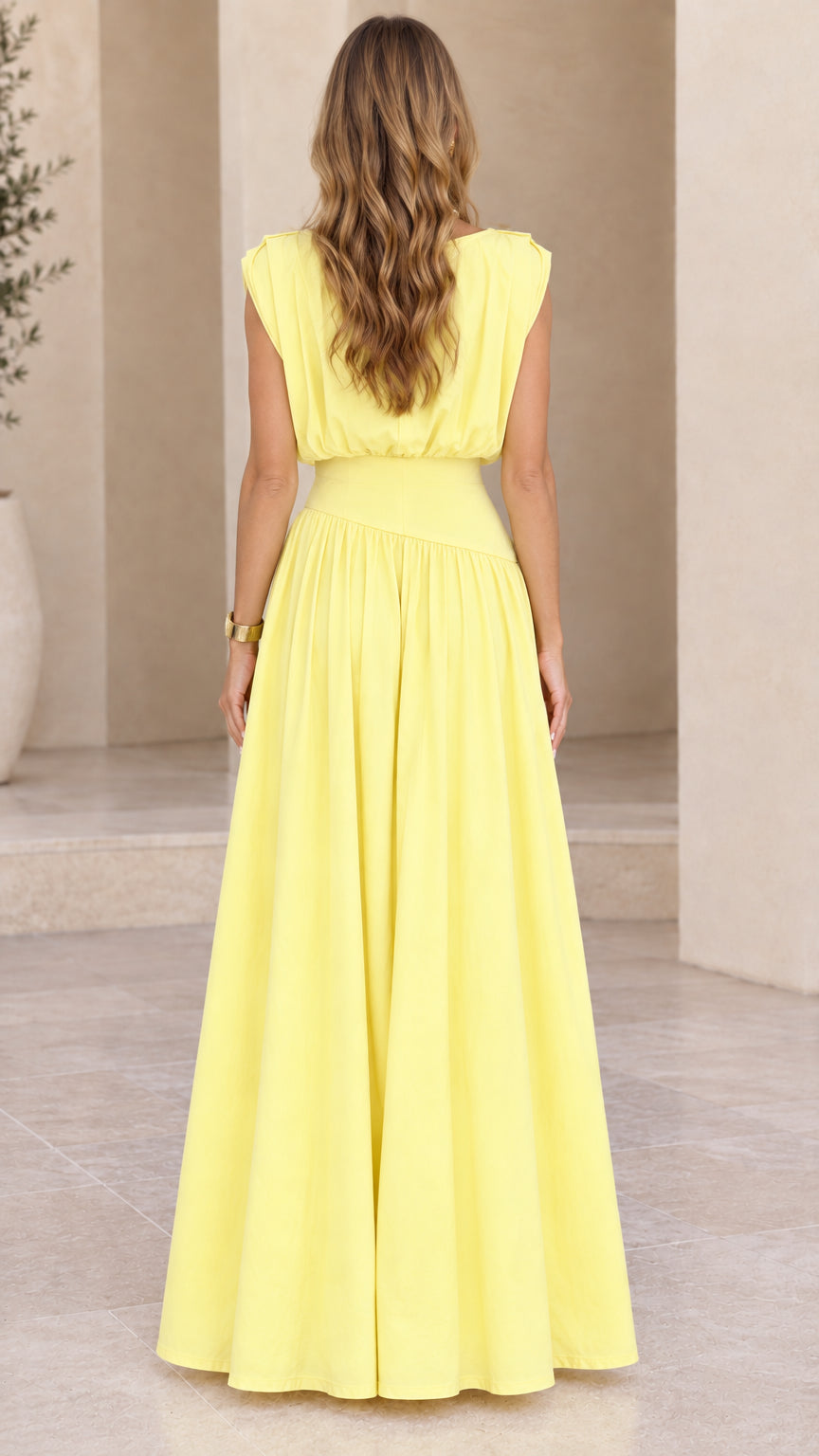 Back view of model wearing yellow sleeveless maxi dress