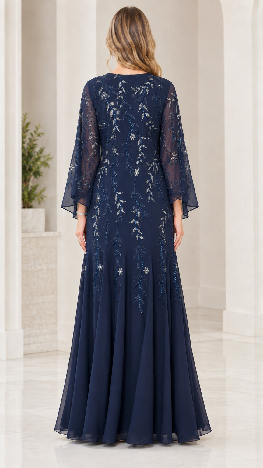 Back view of model showing concealed zip and sheer bell sleeves on Navy Blue gown