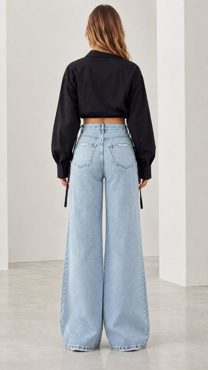 Back view of black long sleeve cropped shirt with wide leg denim