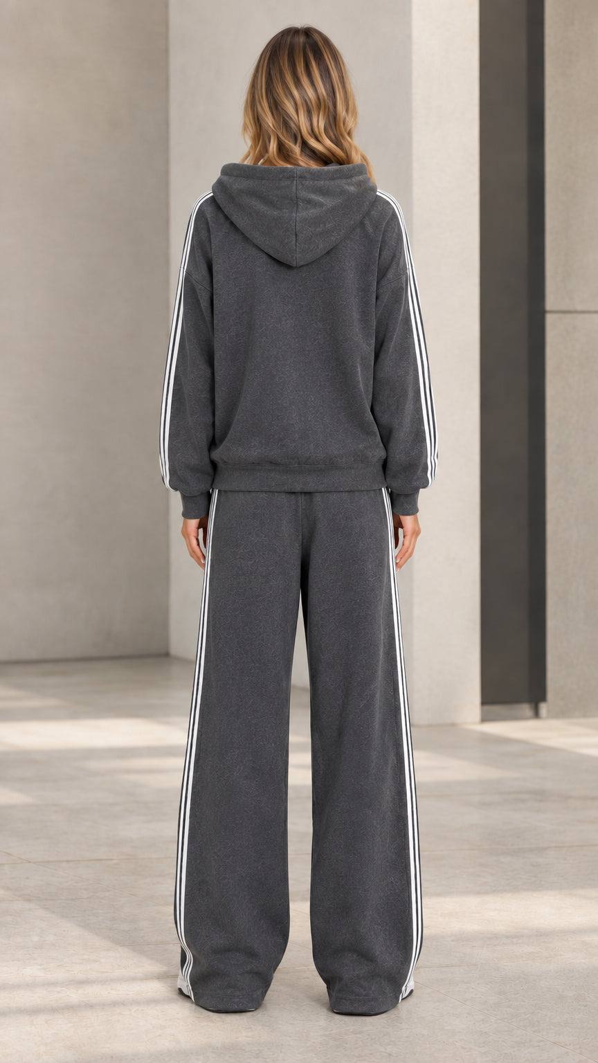Back view of model wearing charcoal grey hooded sweatshirt and wide-leg sweatpants set
