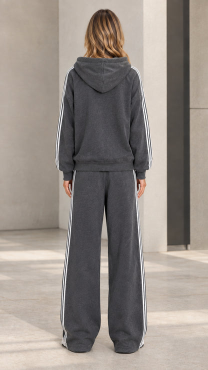 Back view of model wearing charcoal grey hooded sweatshirt and wide-leg sweatpants set