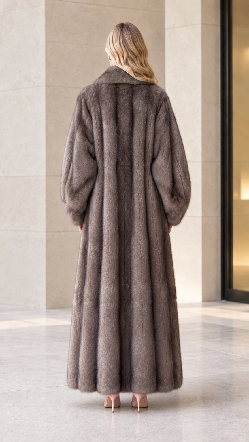 Back view of woman wearing ankle-length taupe textured faux fur coat