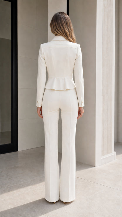 Back view of model showing tailored fit and peplum hem of white blazer set
