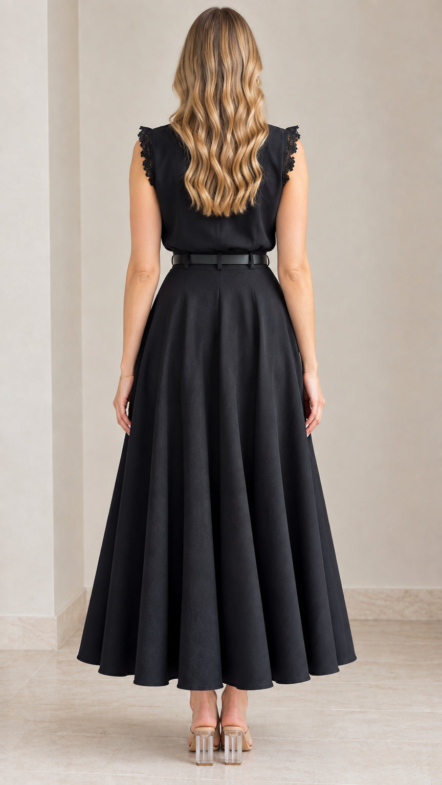 Back view of black sleeveless midi dress showing full skirt
