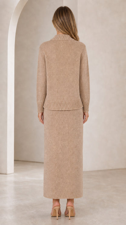 Back view of woman wearing beige knit long sleeve cardigan and column maxi skirt